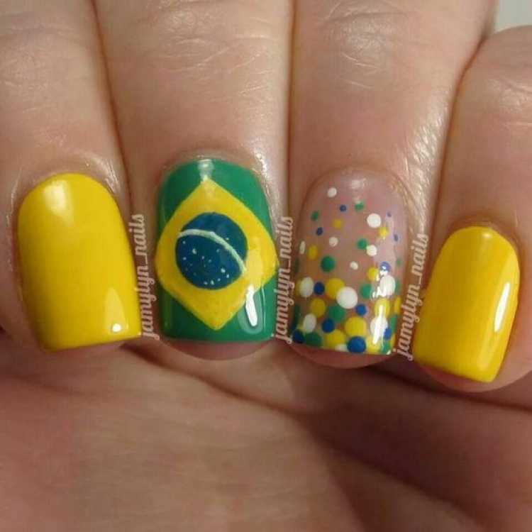Unhas decoradas com a bandeira do Brasil e poás nas cores do Brasil